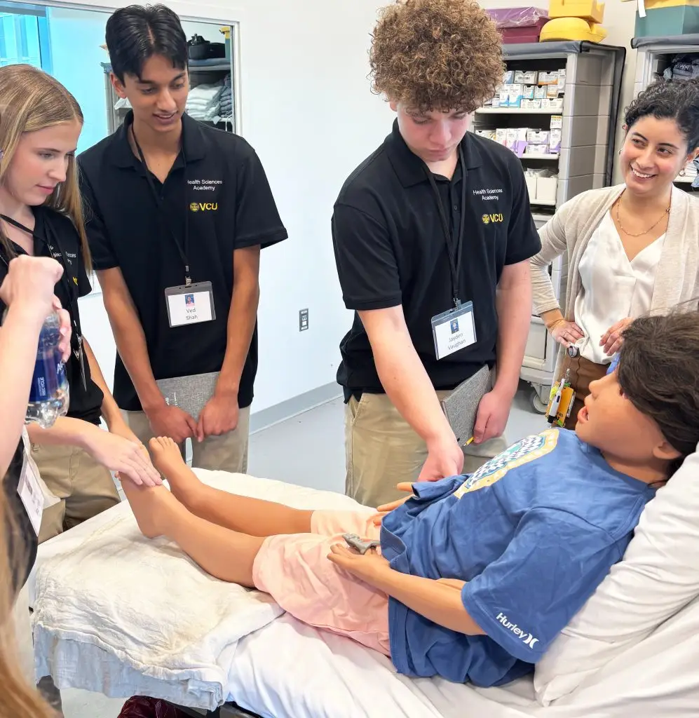 students working on dummy patients
