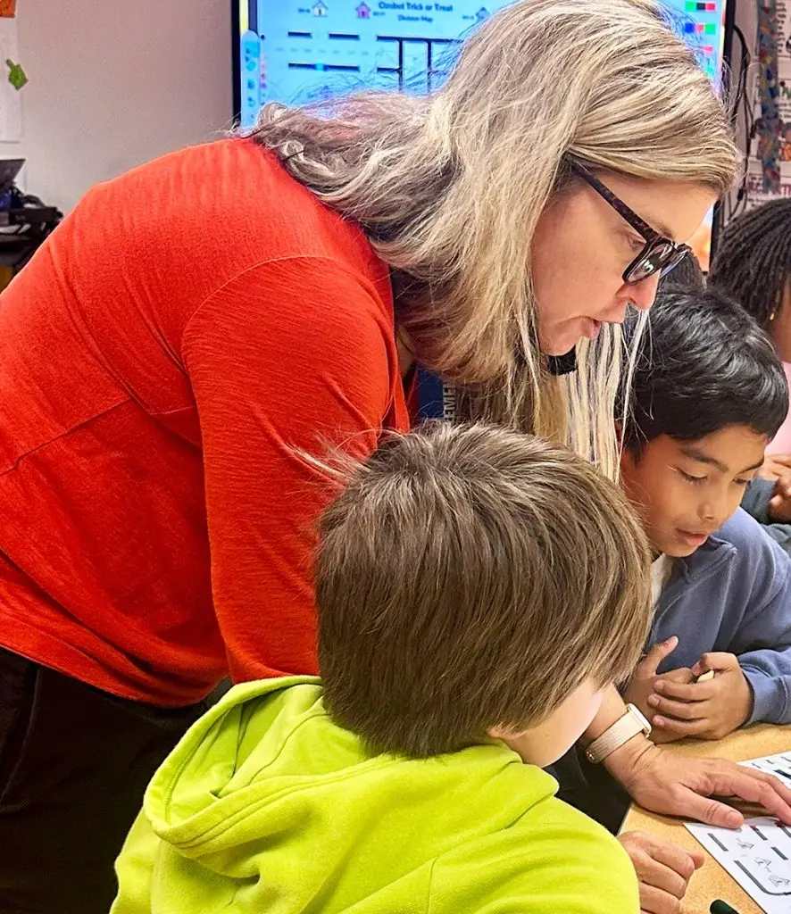 Teacher helping students