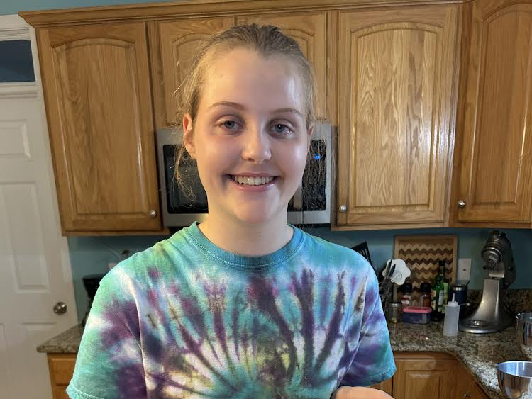A Bird High School student is smiling in her kitchen