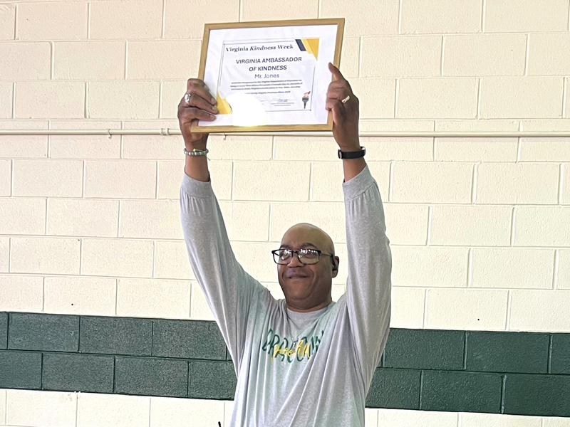Mr. Jones holding up a certificate over his head