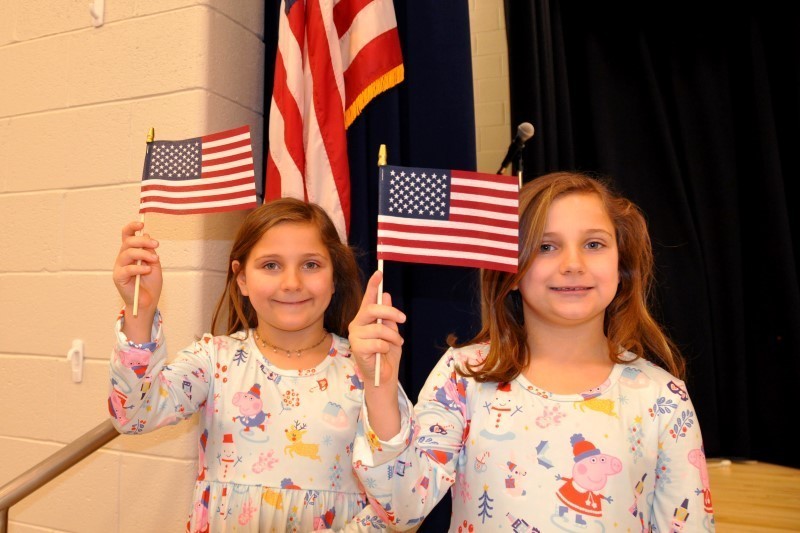 Twins holding American flags