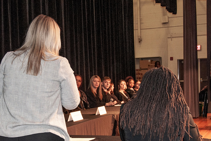 students on stage during event