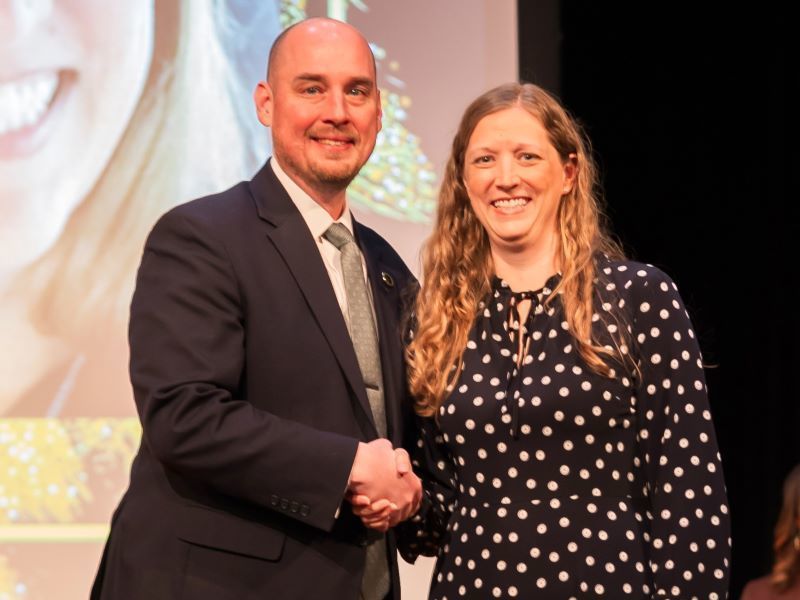 Karen Austin shaking hands with Dr. John Murray