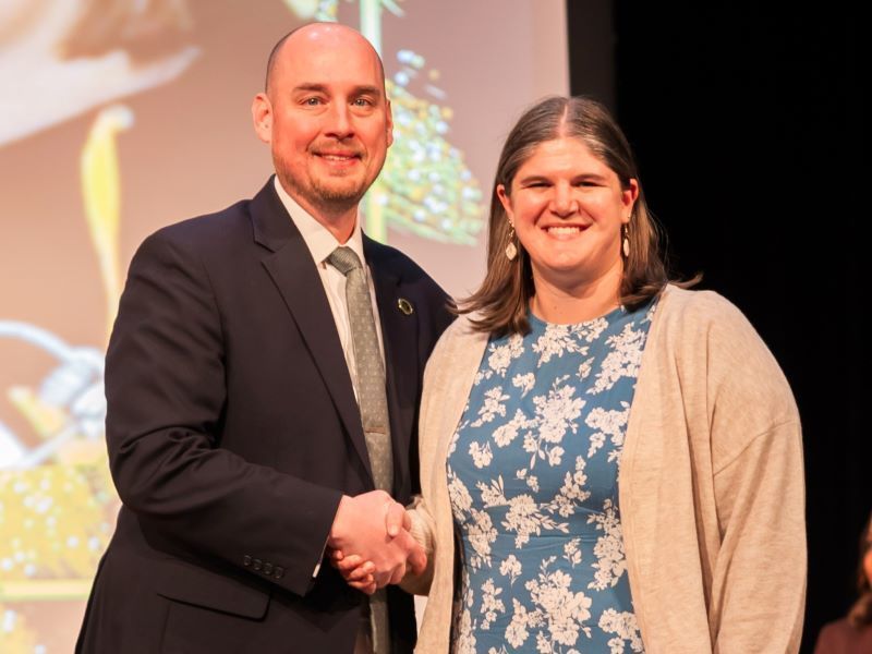 Kelsey Hilton shaking hands with Dr. John Murray