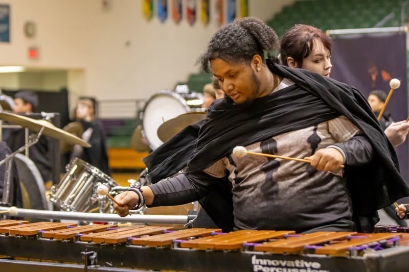 A student playing a xylophone