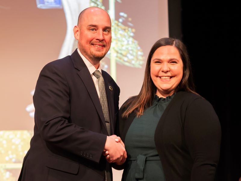 Rachel Kee shaking hands with Dr. John  Murray