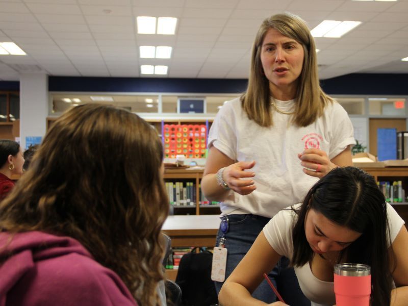 Teacher Erinn Dinsmore speaking to sturents