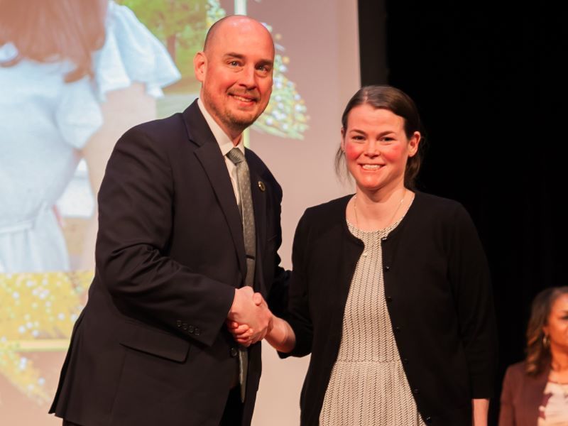 Allison Owens shaking hands with Dr. John Murray