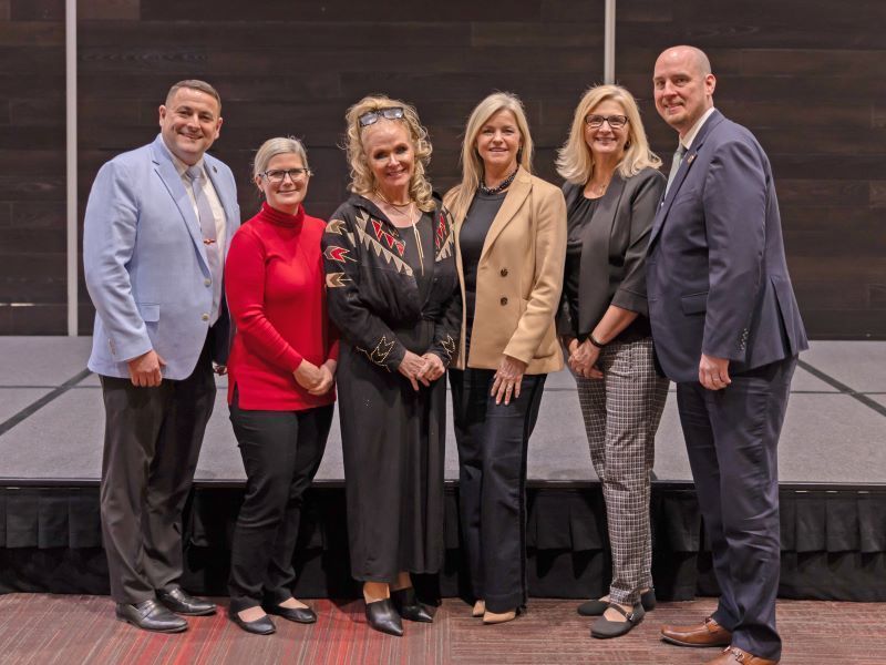 School board members standing with Melissa Ligh