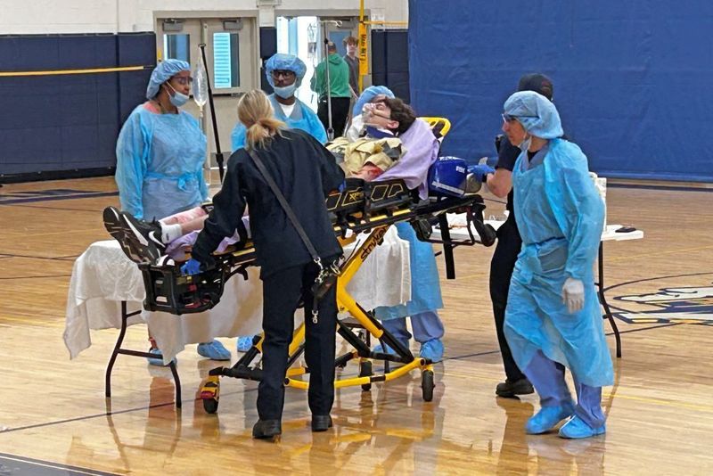 A depiction of an ER team giving medical attention to an injured student