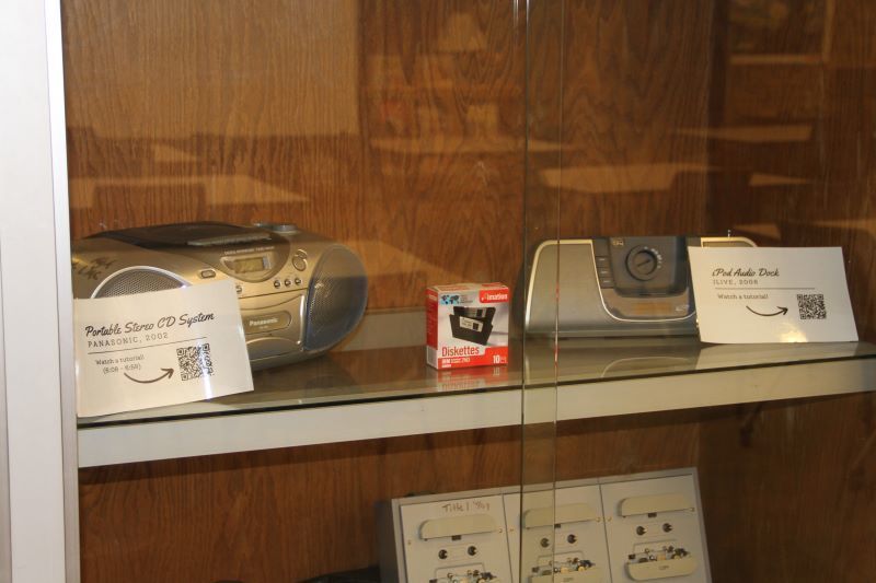 A two radios in a glass cabinet