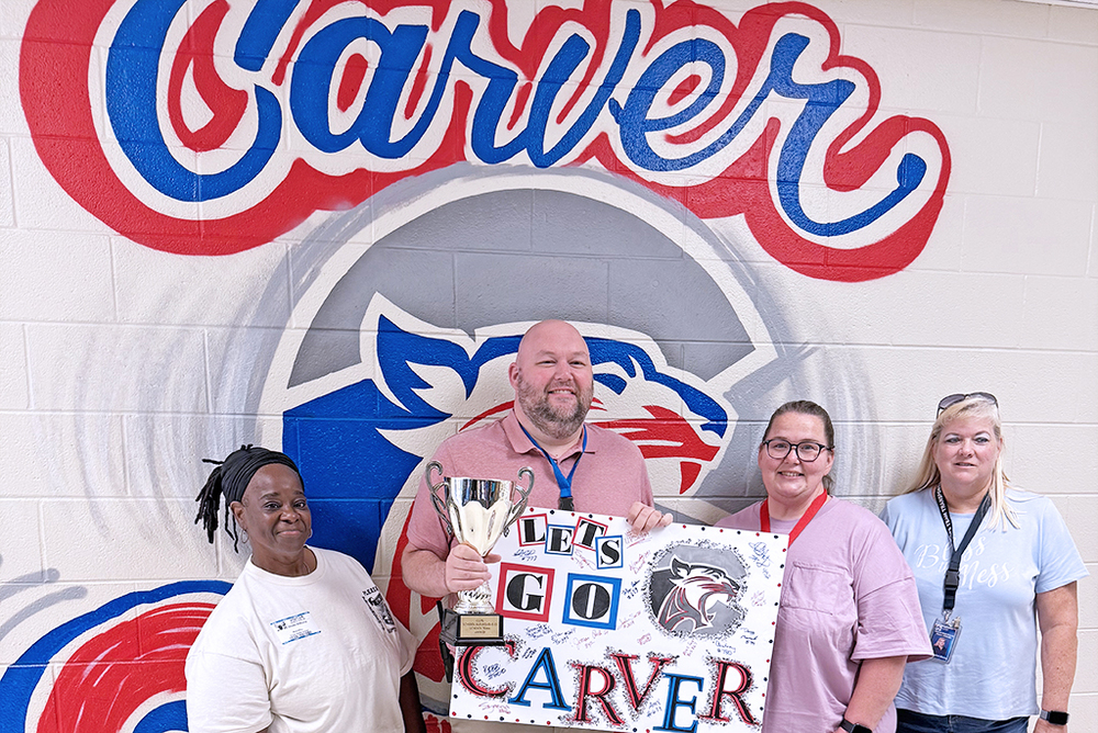 bus drivers pose with their trophy