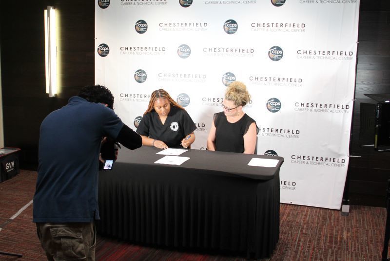 Student being photographed while signing