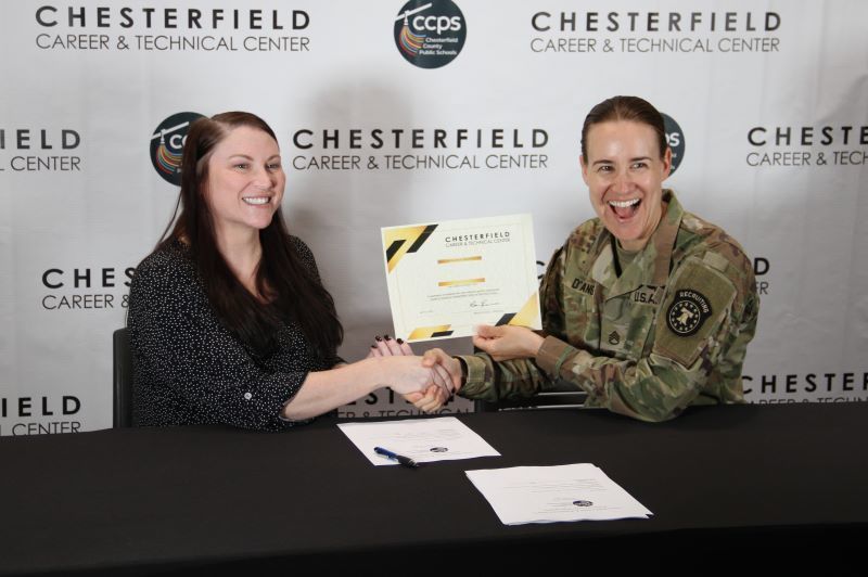 Student smiling with military officer