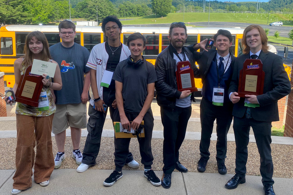 Manchester students posing with awards