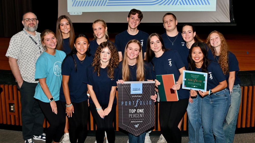 Students holding plaques