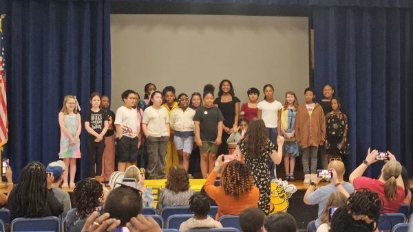 Students in a large group on stage