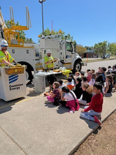 Students sitting next to a utility truck