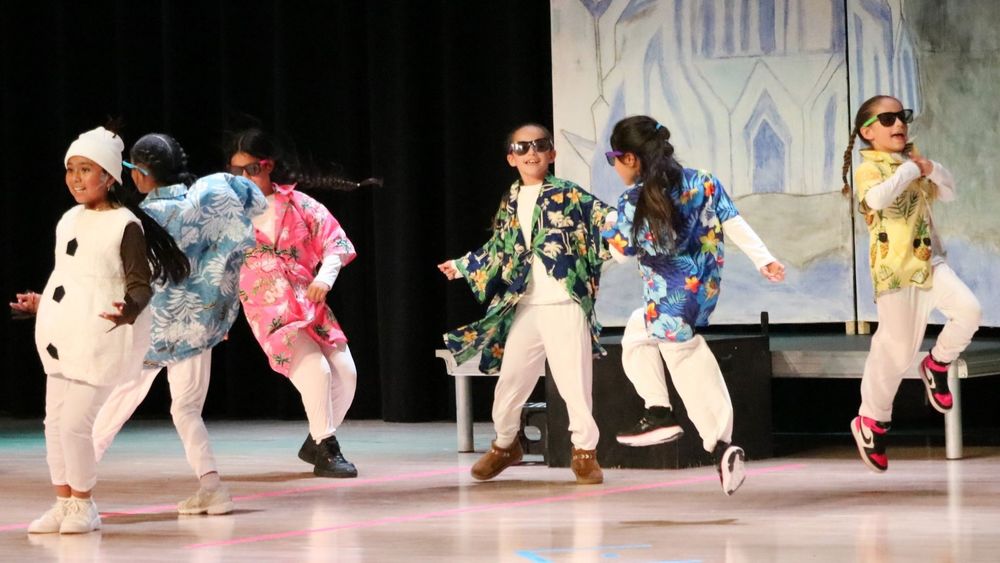 Children in colorful costumes dancing