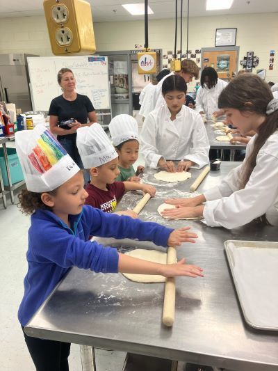 Students rolling out dough