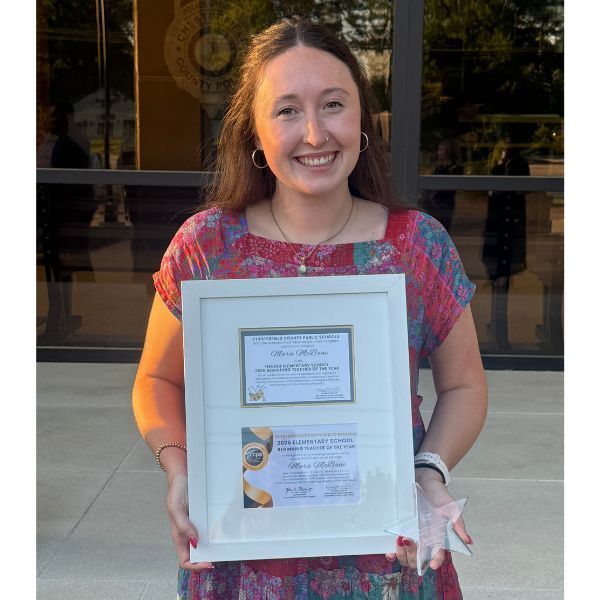 Mara McBane holding an award