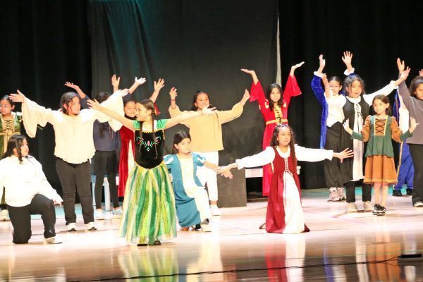 Kids in colorful costumes dancing