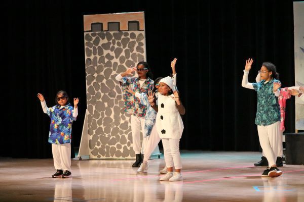 Kids in colorful costumes dancing