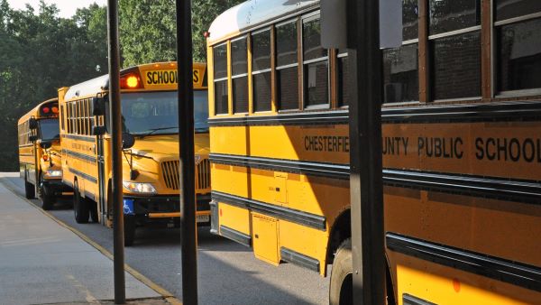 Yellow school buses parked in a row.