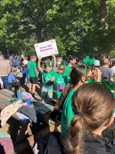 Students in a crowd, one holds a Clover Hill Elementary sign