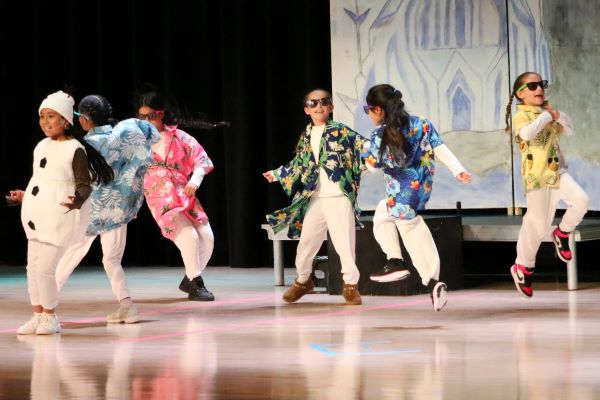 Students participating onstage in the Frozen play