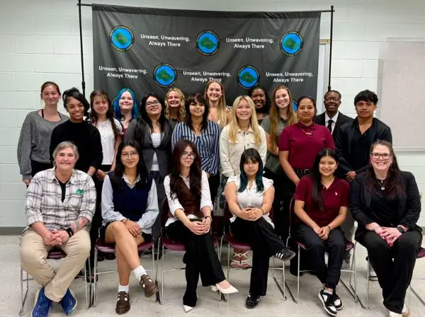 Group of people posing in a classroom. Group of people posing in a classroom.