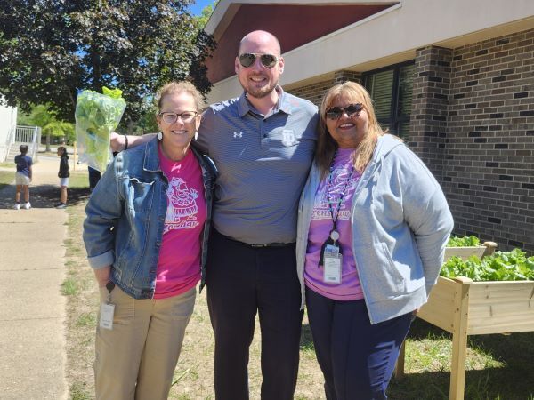 Dr. John Murray and two school staff members smiling