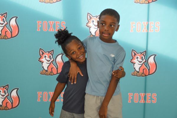 Two students hugging and smiling