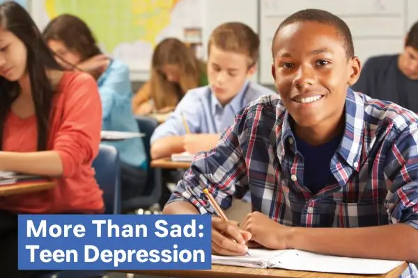 Teen smiling in classroom, "More Than Sad: Teen Depression." Teen smiling in classroom, "More Than Sad: Teen Depression."