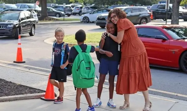 teacher hugs students